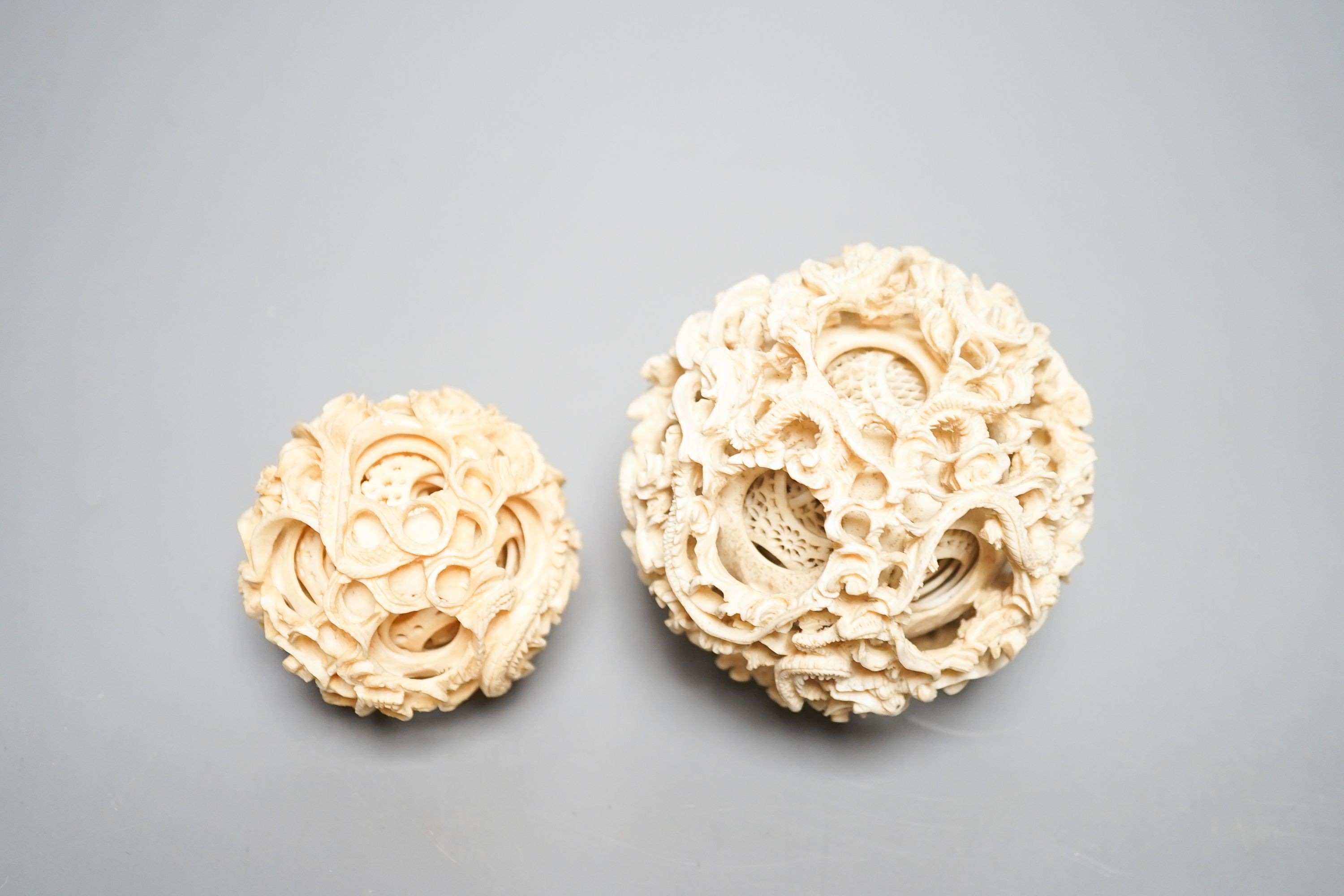 Two Chinese concentric ivory puzzle balls, first half 20th century, largest 8.6cm